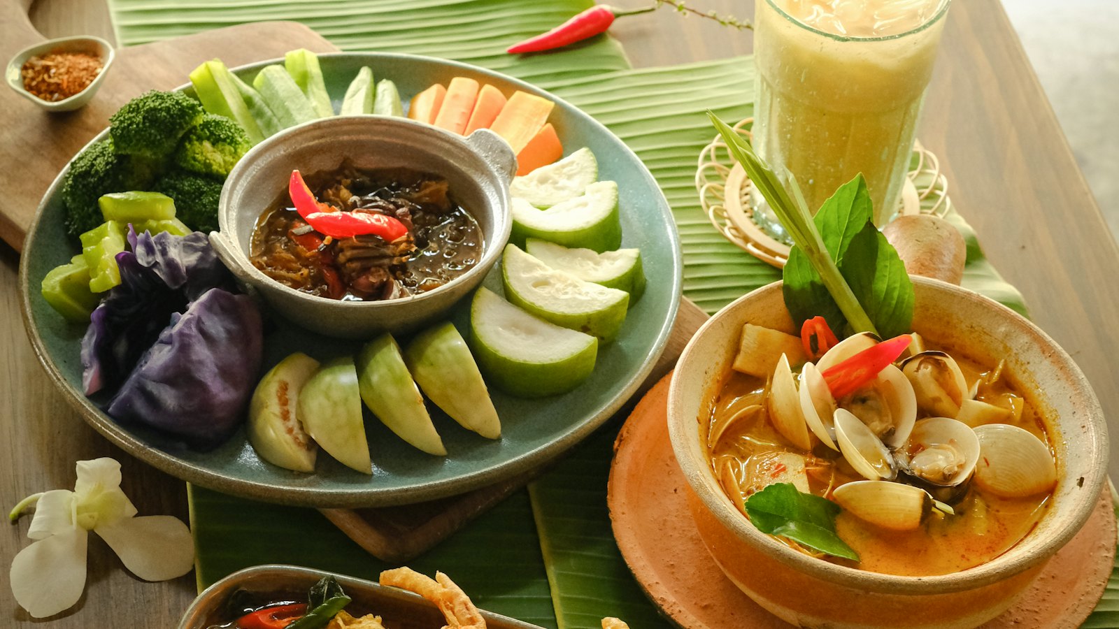 A set of dishes with dips, vegetables and soup