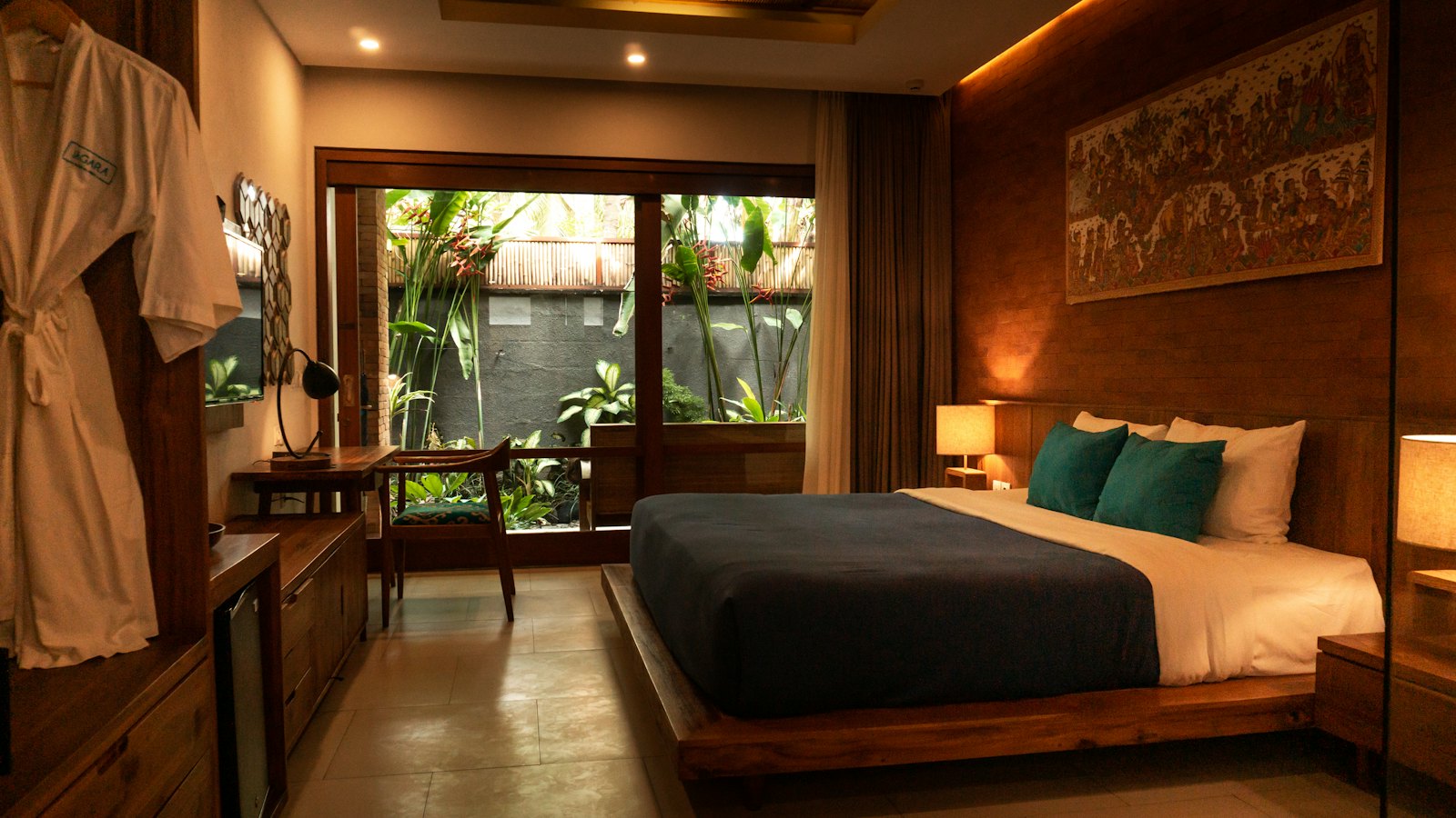 A hotel bedroom with a wooden bed
